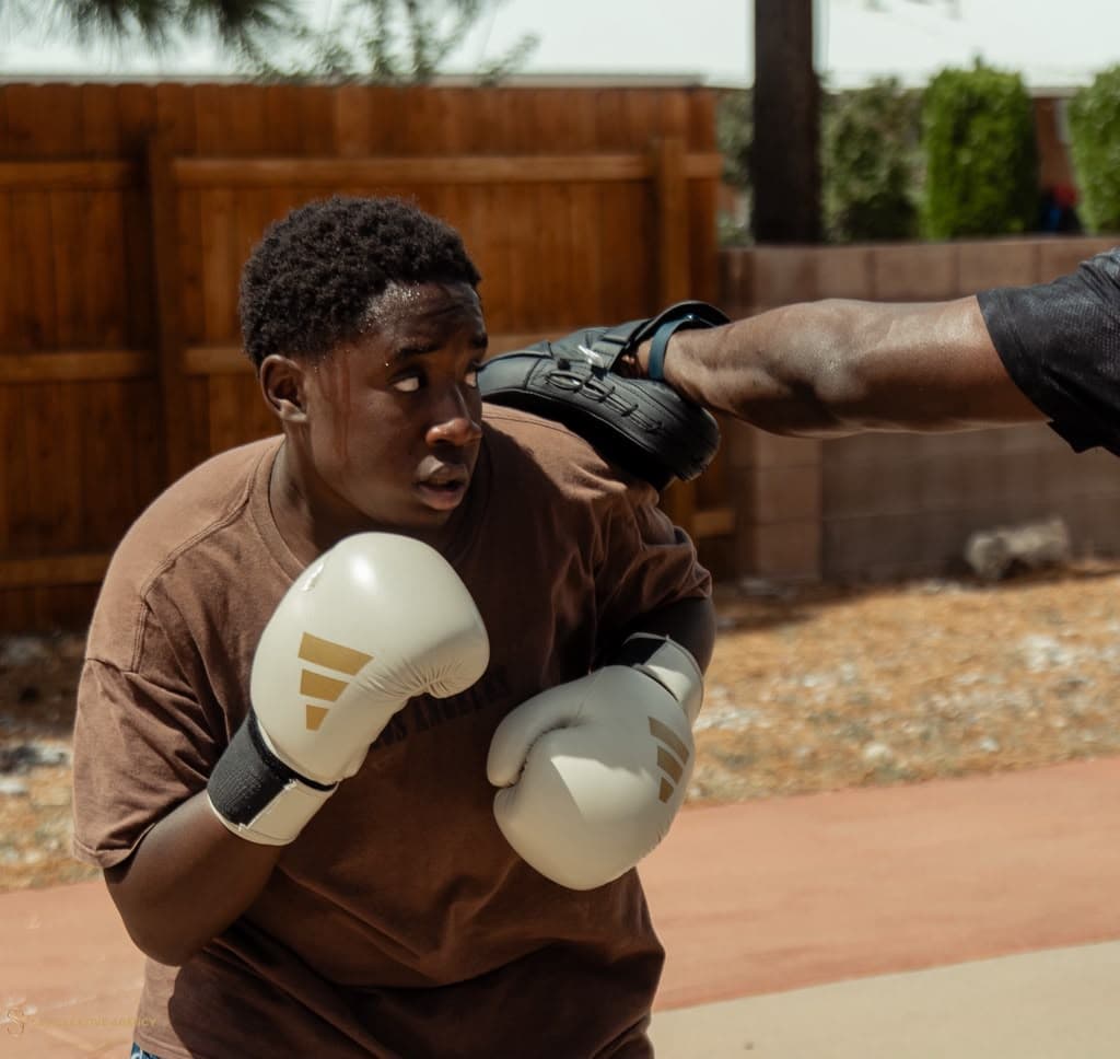 Boxer slipping a punch during pad work